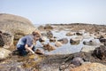 Boy exploring tide pools on New Hampshire coast