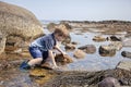 Boy exploring tide pools on New Hampshire coast Royalty Free Stock Photo