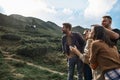 Curious friends smiling and looking at the flying dron