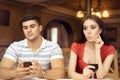 Curious Girl Spying Boyfriend on Smartphone Royalty Free Stock Photo