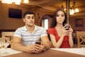 Curious Girl Spying Boyfriend on Smartphone Royalty Free Stock Photo