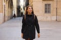 Curious girl travelling and visiting Europe in winter time. Backpacker girl walking in Valencia admiring spanish architecture Royalty Free Stock Photo