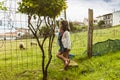 Curious girl watching the sheeps in the countryside