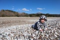 Curious happy little baby child crawling on the pebble beach in Cirali, Turkey under blue sky Royalty Free Stock Photo