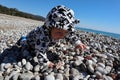 Curious happy little baby child crawling on the pebble beach under blue sky Royalty Free Stock Photo