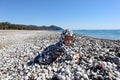 Curious happy little baby child crawling on the pebble beach under blue sky Royalty Free Stock Photo