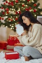 Woman With Present in the Gift Box Near Christmas Tree at Home Royalty Free Stock Photo