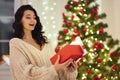 Woman With Present in the Gift Box Near Christmas Tree at Home Royalty Free Stock Photo