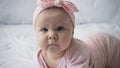 curious infant baby in headband with