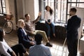 Curious intern raising hand, asking question to coach at briefing Royalty Free Stock Photo