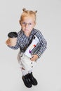 Cropped portrait of cute little girl in casual clothing and stylish glasses isolated over gray background Royalty Free Stock Photo