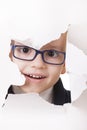 Curious kid looks through a hole in paper Royalty Free Stock Photo