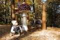 Curious kid playing by giant wooden mushrooms Royalty Free Stock Photo