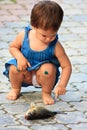 Curious little Caucasian girl touching fish caught on picnic. Childhood concept. Perception, education and upbringing concept