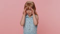 Curious little child girl kid closing eyes with hand and spying through fingers, hiding and peeping Royalty Free Stock Photo