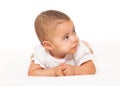 Curious looking African baby in white bodysuit Royalty Free Stock Photo