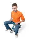 Curious man on a children's bicycle on white