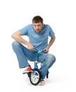 Curious man on a children's bicycle on white