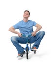 Curious man on a children's bicycle on white background