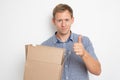 curious man looking inside a cardboard box he holds in his hands on a white background Royalty Free Stock Photo