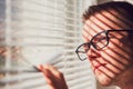 Curious man looking through a jalousie Royalty Free Stock Photo