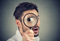 Curious man looking through a magnifying glass Royalty Free Stock Photo