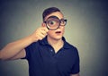 Curious man looking through a magnifying glass Royalty Free Stock Photo