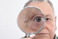 Curious man peering through magnifying glass