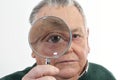 Curious man peering through magnifying glass