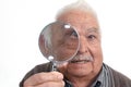 Curious man peering through magnifying glass