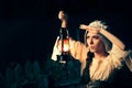 Curious Medieval Woman with Vintage Lantern Outside at Night