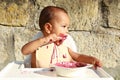 Curious messy baby boy eating blueberry cake Royalty Free Stock Photo