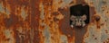 Curious mouse peeking through rusty metal hole in weathered surface, copy space for text Royalty Free Stock Photo