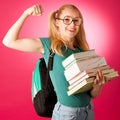 Curious, naughty, playful schoolgirl with stack of books and big