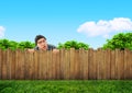 Curious neighbor behind backyard fence Royalty Free Stock Photo