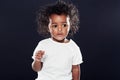 The curious one. a cute girl on a black background. Royalty Free Stock Photo