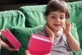 Curious shy kid girl looking inside gift box with present Royalty Free Stock Photo