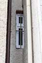 Curious small window in the niche between two buildings, Germany