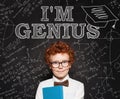 Curious smart kid little school boy genius on blackboard background