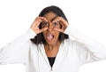 Curious surprised shocked woman peeking, through fingers like binoculars Royalty Free Stock Photo