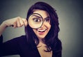 Curious surprised young woman looking through a magnifying glass Royalty Free Stock Photo