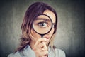 Curious woman looking through a magnifying glass Royalty Free Stock Photo