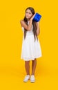 curious teen girl hold present box on yellow background