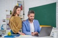 curious teen kid with man teacher in classroom. education