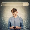 Curious teenager boy using his mobile phone browsing network search bar to find useful information and data. Internet searching Royalty Free Stock Photo