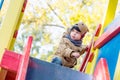 Curious Toddler boy climbing on playground