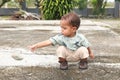 Curious toddler boy throwing stone