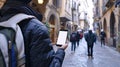 a curious tourist stands clutching a smartphone with a blank, white screen in a foreign city