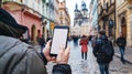 a curious tourist stands clutching a smartphone with a blank, white screen in a foreign city