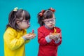 Curious twin sisters with mental disorder examining holiday cakes Royalty Free Stock Photo